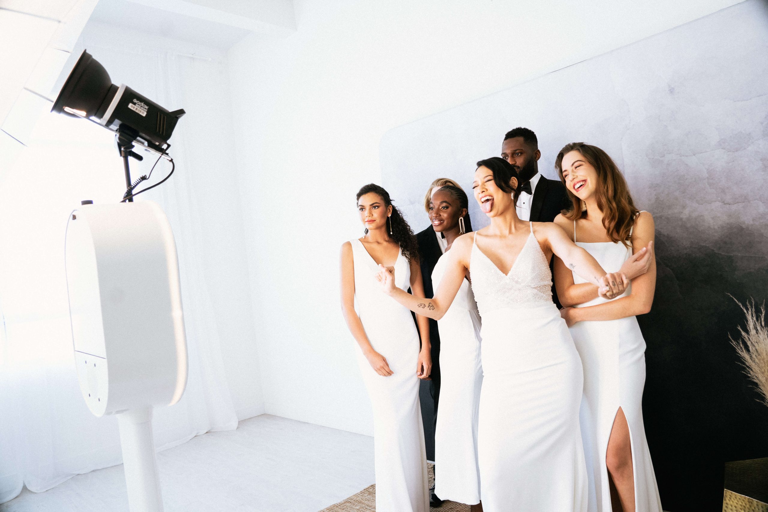 A group of bridesmaids posing at the wedding photo booth.